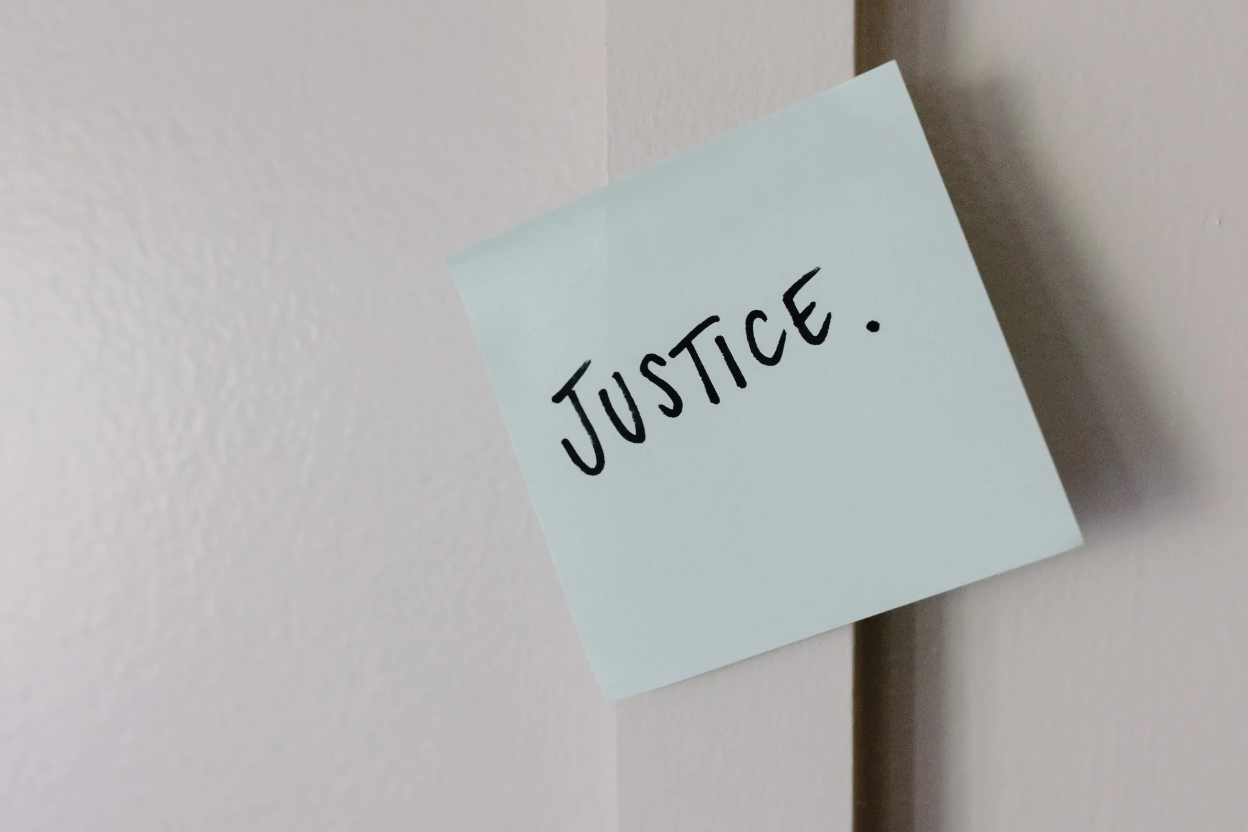 Photo by Tara Winstead: https://www.pexels.com/photo/the-word-justice-written-on-paper-8850833/